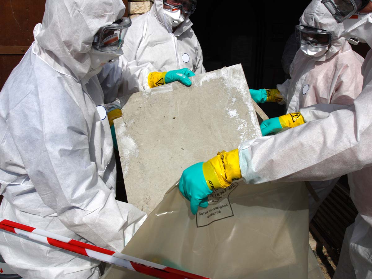 Specialists in hazmat suits removing asbestos